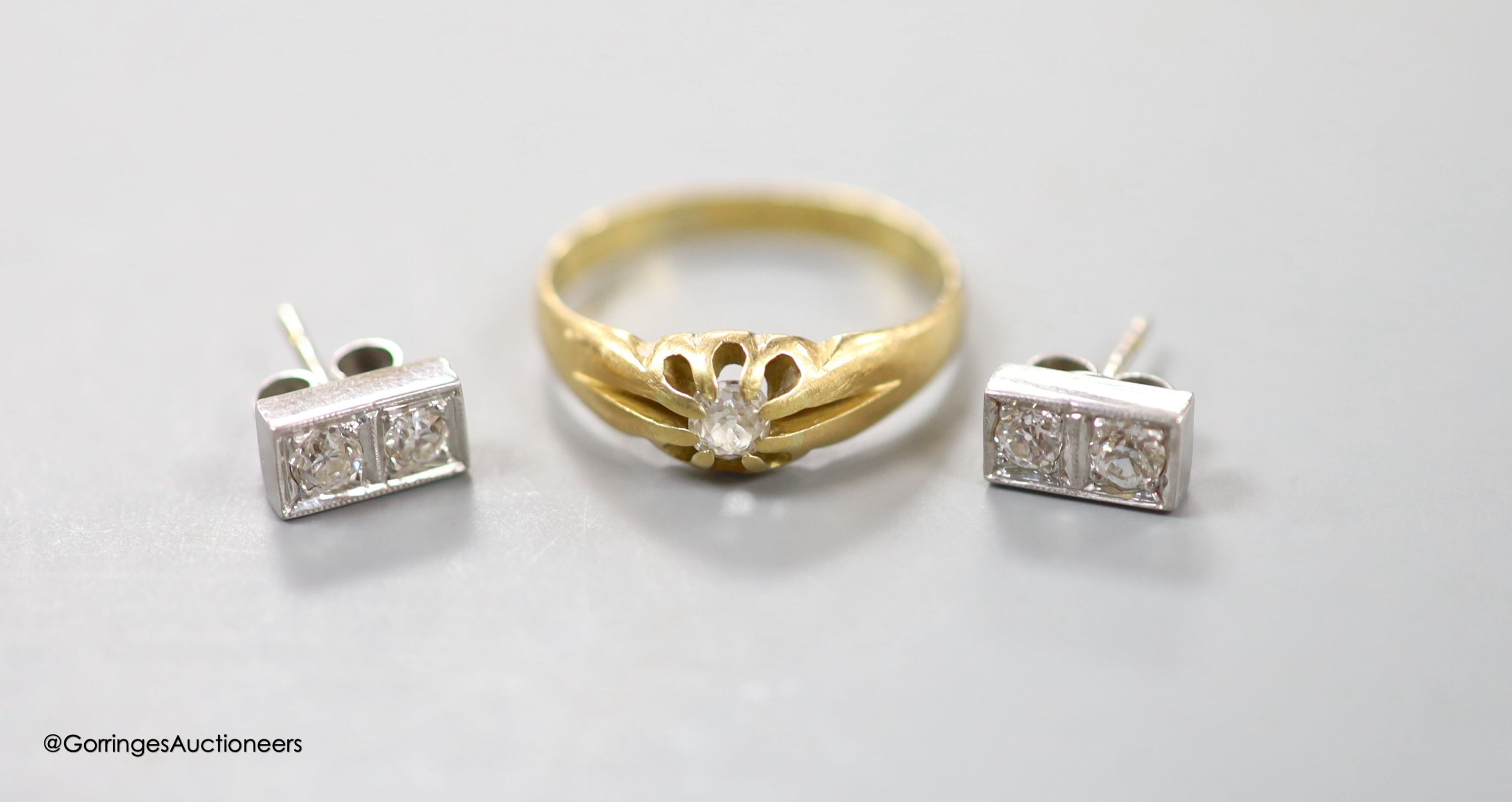 A pair of diamond and 18ct white gold earrings and a diamond solitaire ring, 18ct gold shank, gross 5.6 grams.